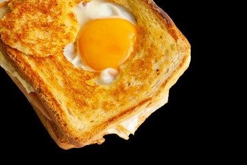 Ham and cheese sandwich with fried egg isolated on black background