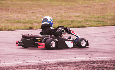 Child drives in go-kart on track during competition