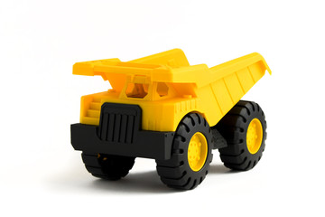 yellow plastic  dump truck toy on white background