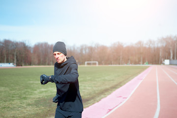 Image of sportsman running through stadium during spring jog.