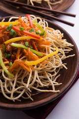 American chop suey/ chopsuey is a popular indochinese food. served in a bowl with chop sticks. selective focus