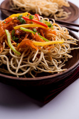 American chop suey/ chopsuey is a popular indochinese food. served in a bowl with chop sticks. selective focus