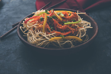 American chop suey/ chopsuey is a popular indochinese food. served in a bowl with chop sticks. selective focus