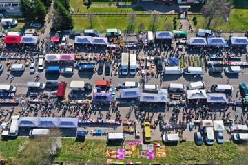 Aerial view on flea market with miscellaneous items and crowds of buyers and seller's makeshift stands
