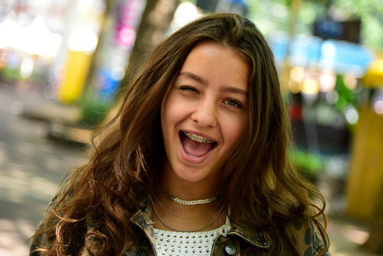 Portrait of winking teenage girl wearing braces