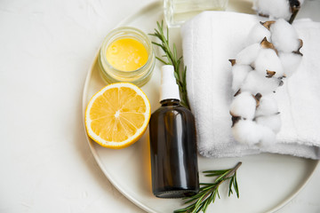 Spa still life with face mist spray bottle, cotton buds and towel