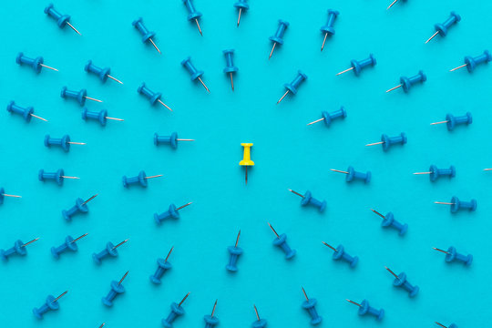 yellow push pin out of the crowd conceptual photo of attack on person for views