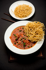 American chop suey/ chopsuey is a popular indochinese food. served in a bowl with chop sticks. selective focus