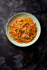 American chop suey/ chopsuey is a popular indochinese food. served in a bowl with chop sticks. selective focus