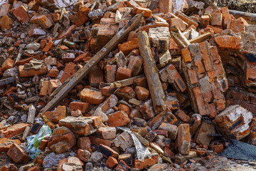 bunch of broken red bricks and other debris