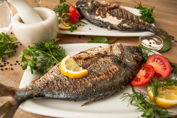 Fish Dorada grilled served in a white plate