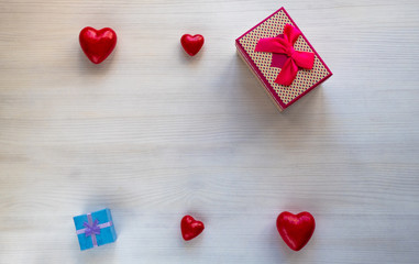 gift box surrounded by hearts on a white table. Present. Place for inscription. Mothers Day