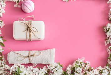 Spa still life on an isolated pink background with spring flowe