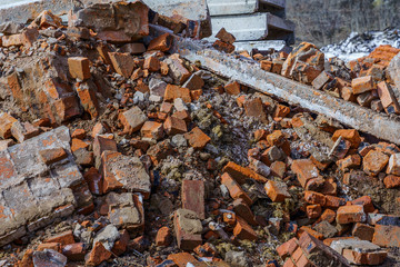 bunch of broken red bricks and other debris