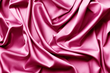 Smooth elegant  pink silk or satin texture can use as abstract background. Luxurious background design