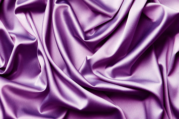 Smooth elegant  purple silk or satin texture can use as abstract background. Luxurious background design