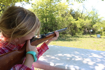Girl aiming to shoot at target