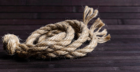 Fototapeta na wymiar Hemp rope on a dark wooden background