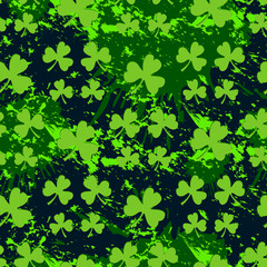 Vector seamless pattern with green clover on a dark blots background