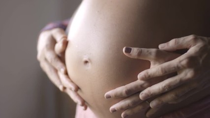 Mom and dad hands on pregnant tummy. Pregnant couple caressing pregnant belly. Happy family. pregnancy, motherhood, maternity, people and expectation concept