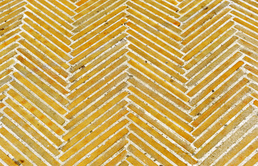 Brick pavement placed in spike, background and texture of a Spanish sidewalk