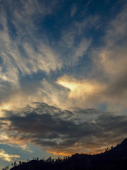 Astonishing cirrus clouds formation at sunset over the Andean mountains of central Colombia. (vertical)