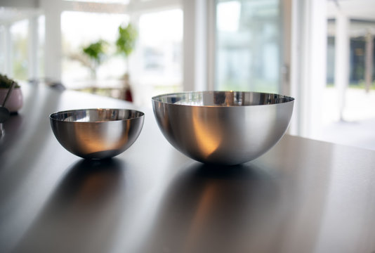Two metal bowls in a modern kitchen. Minimalistic interior kitchen design