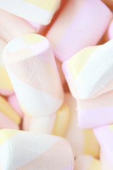 Fototapeta na wymiar Pastel pink, yellow marshmallows background