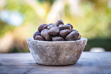 Cashew - bowl filled of raw nuts in the shell