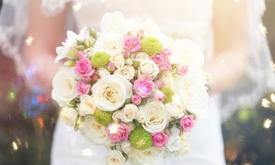 Bride with beautiful wedding bouquet on background