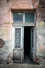 Fototapeta na wymiar Old doors of old ruined abandoned house