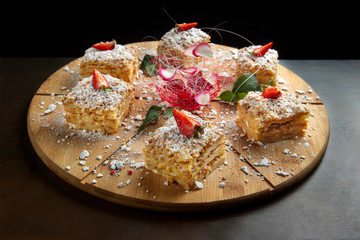 Six piece of cake Napoleon on wooden tray. Russian cuisine, layered cake with pastry cream-2.