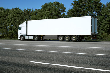 White truck is going up the road. Cargo transportation concept.