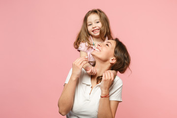 Woman in light clothes have fun with cute child baby girl. Mother, little kid daughter isolated on...