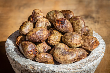 Cashew - bowl filled of raw nuts in the shell