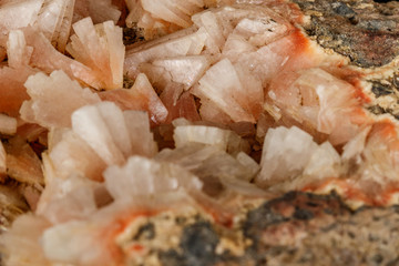 Macro of a stone Stilbite mineral on a black background
