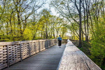Kunratice forest - beautiful green park with path and bridge during sunset in Prague (secret gem, popular travel destination in Czech Republic, Europe)