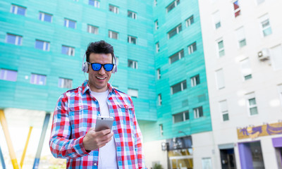 Young man with Mobile in the city