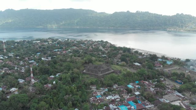 Aerial: flying over Bandaneira village Fort Belgica Indonesia Banda Islands Maluku, diving travel destination, old dutch colony for nutmeg. Native cinelike D-log color profile