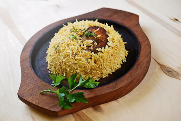 Traditional indian meal with parsley leaf on wooden plate.
