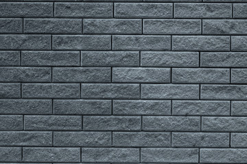 Abstract gray pattern of brick wall background. Light grey stone background. Grey bricks texture wallpaper backdrop of house facade. Gray decorative tiled wall. Interior decoration