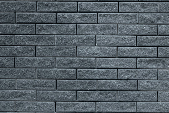 Fototapeta Abstract gray pattern of brick wall background. Light grey stone background. Grey bricks texture wallpaper backdrop of house facade. Gray decorative tiled wall. Interior decoration