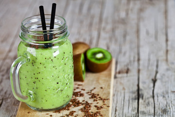 Green smoothie with kiwi, apple, lemon and linen seeds. Healthy fresh diet eating.