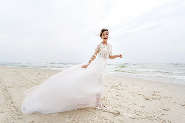 Fototapeta na wymiar bride develops her dress on the background