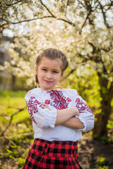 beautiful girl in traditional embroidered shirt jacket in the garden. Ukraine