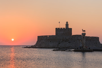 sunrise in Mandraki harbour. Rhodes, Greece