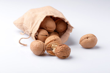 Walnuts in a bag on a white background.