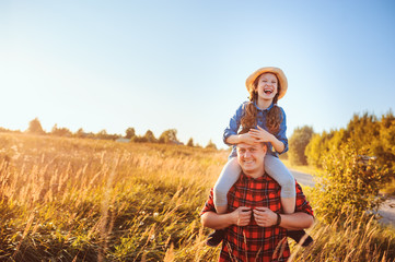 happy father and daughter walking on summer meadow, having fun and playing. Father's day,...