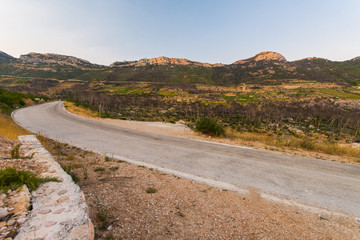 road to small village Trstenik in Peljesac peninsula, with mountins and blue sky as background