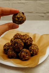 Energy balls - healthy snack rich with fibers and protein. Recipe with oats, walnuts, dates and raisins, selective focus